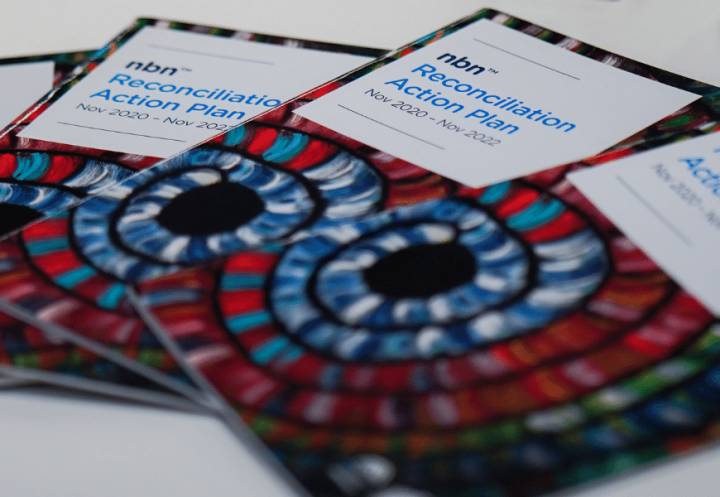 Hard copies of nbn's Reconciliation Action Plan laid out on table